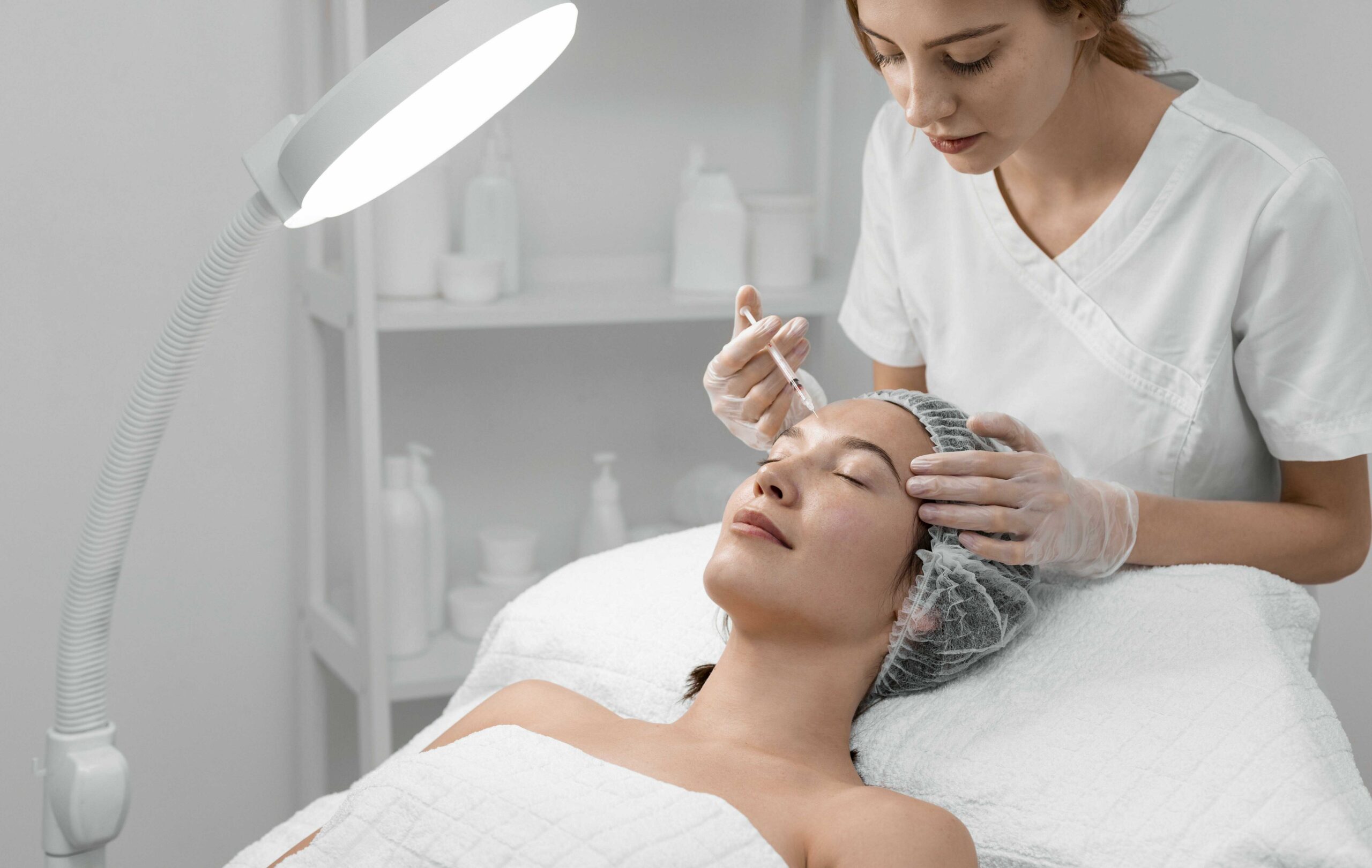 beautician-doing-filler-injection-female-client_optimized